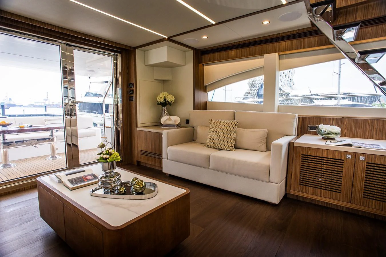 a living room with a large window aboard 70' JOHNSON SKYLOUNGE 2026 Yacht for Sale