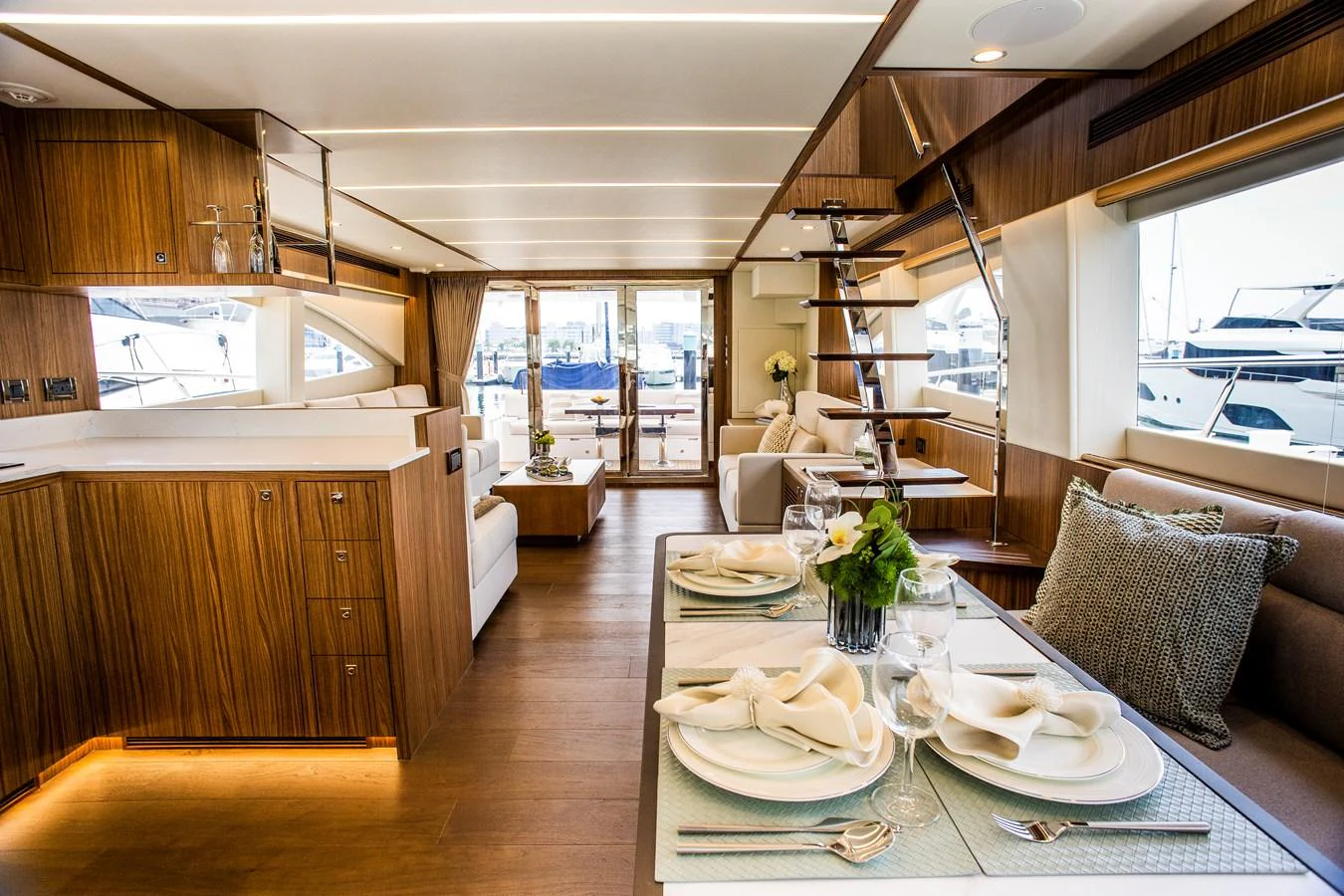 a dining room with a table and chairs aboard 70' JOHNSON SKYLOUNGE 2026 Yacht for Sale