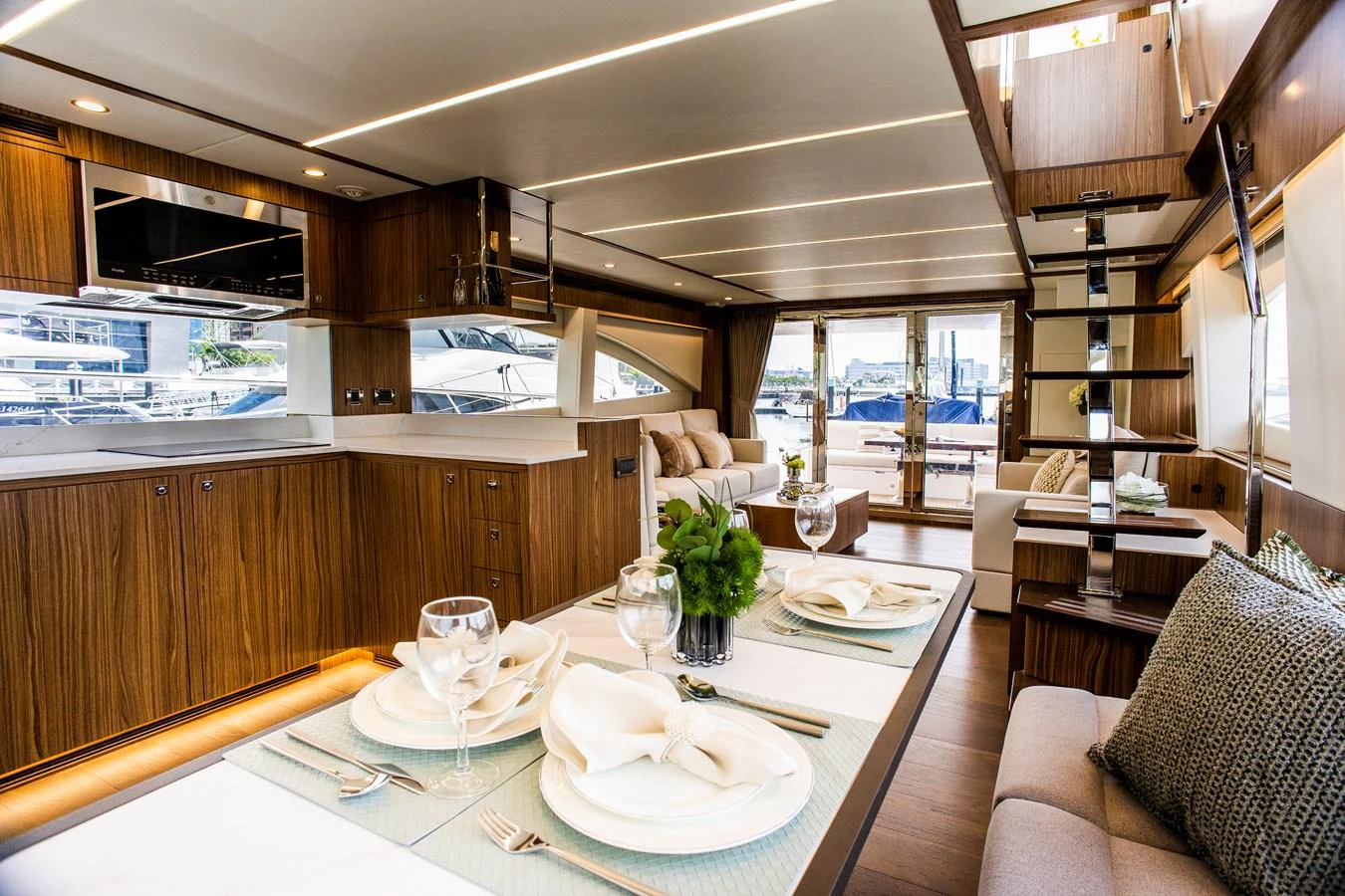 a large kitchen with a dining table aboard 70' JOHNSON SKYLOUNGE 2026 Yacht for Sale