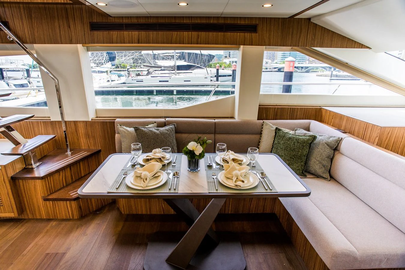 a table with plates and glasses on it aboard 70' JOHNSON SKYLOUNGE 2026 Yacht for Sale
