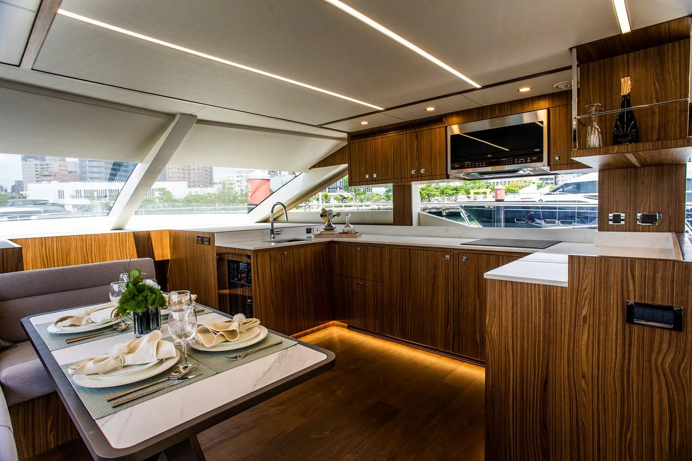 a kitchen with a table and plates aboard 70' JOHNSON SKYLOUNGE 2026 Yacht for Sale