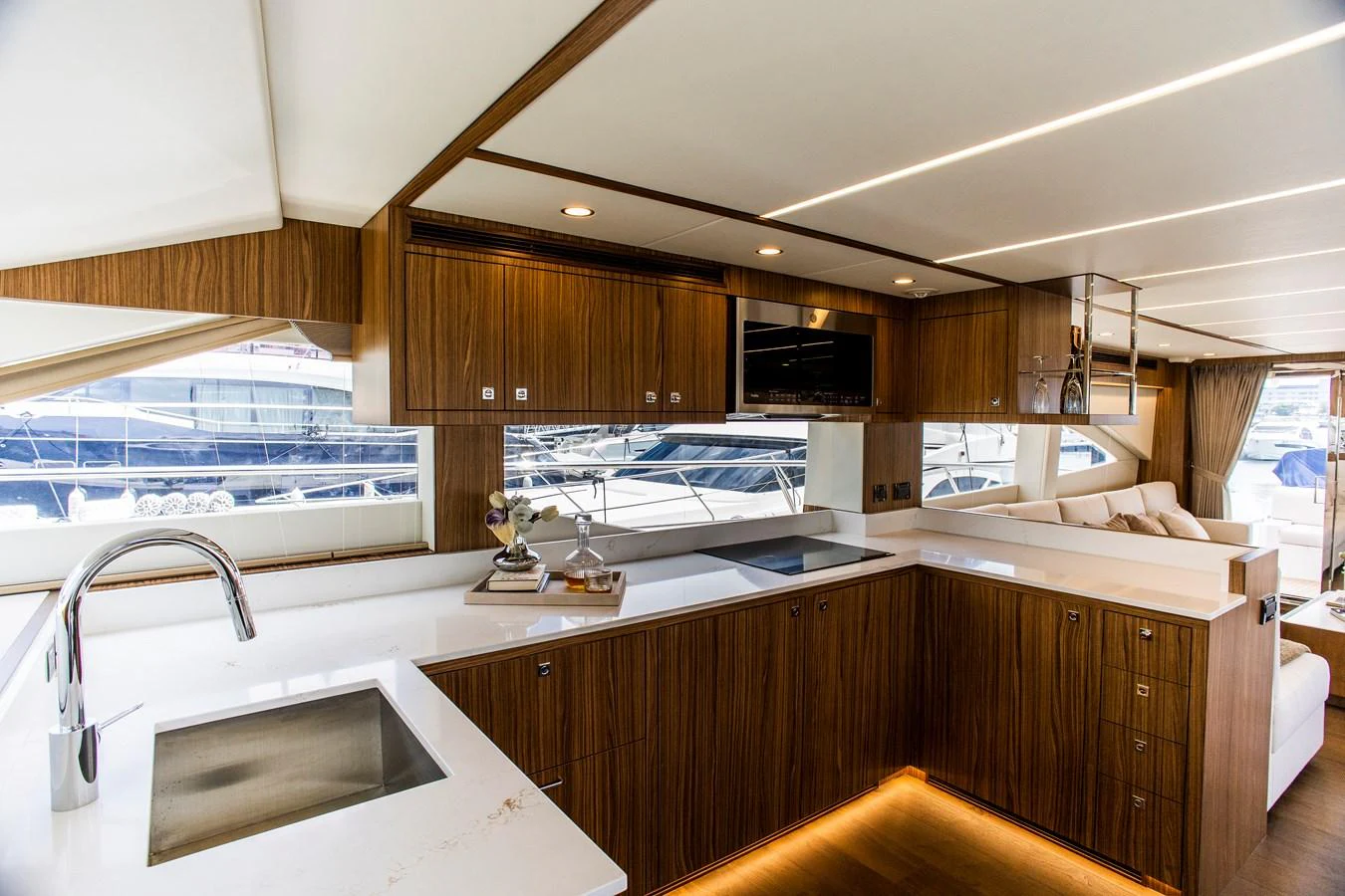 a kitchen with wooden cabinets aboard 70' JOHNSON SKYLOUNGE 2026 Yacht for Sale