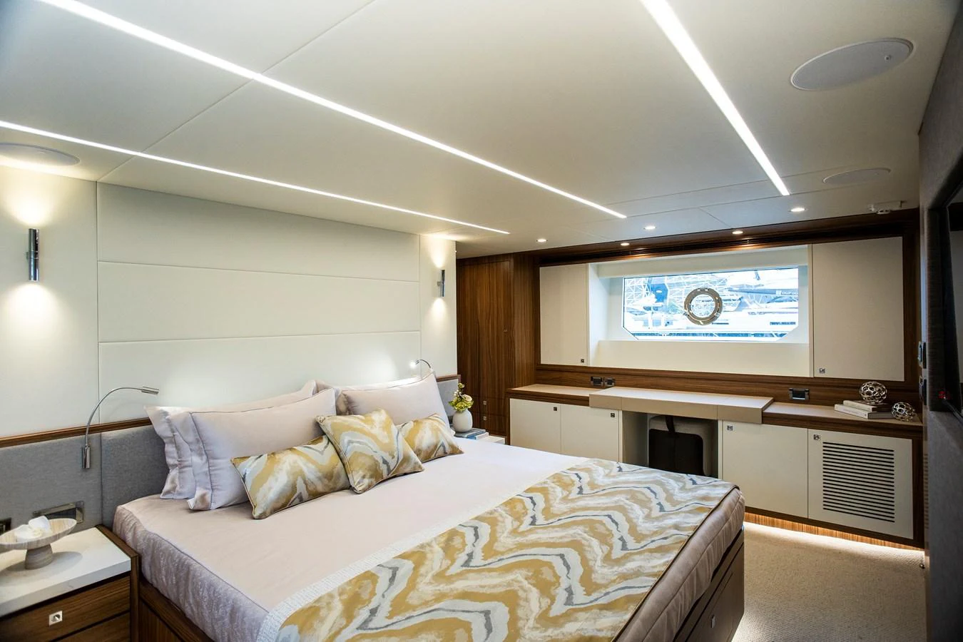 a room with a bed and a television aboard 70' JOHNSON SKYLOUNGE 2026 Yacht for Sale