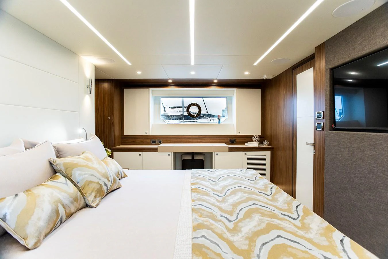 a bedroom with a bed and a television aboard 70' JOHNSON SKYLOUNGE 2026 Yacht for Sale