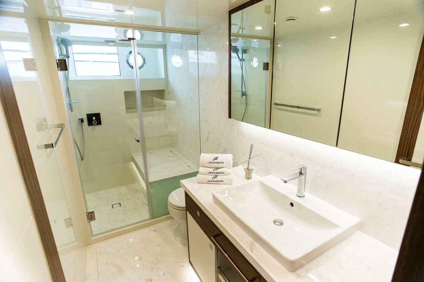 a bathroom with a glass shower aboard 70' JOHNSON SKYLOUNGE 2026 Yacht for Sale