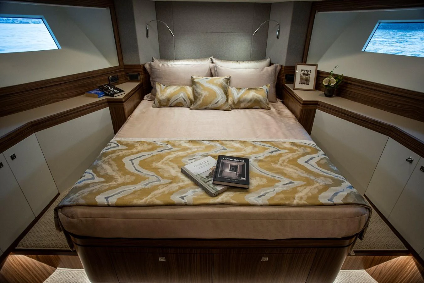 a bed with a laptop on it aboard 70' JOHNSON SKYLOUNGE 2026 Yacht for Sale