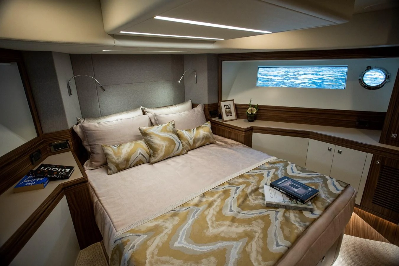 a bed with a television on the wall aboard 70' JOHNSON SKYLOUNGE 2026 Yacht for Sale