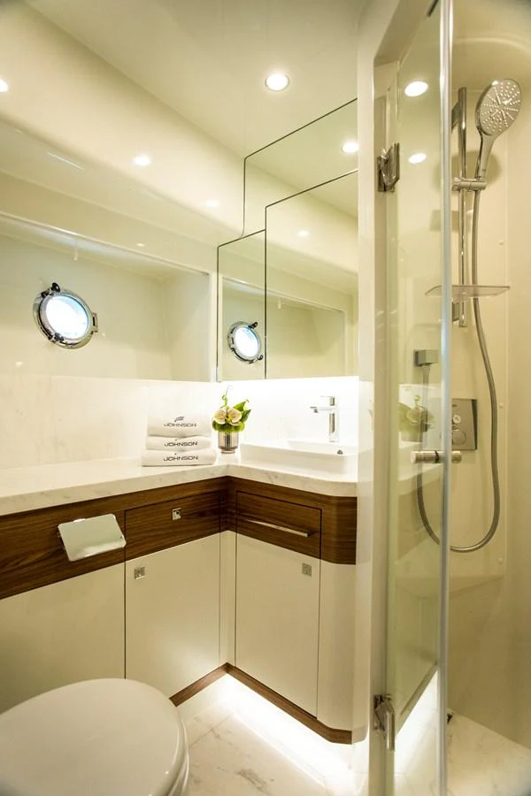 a bathroom with a glass shower aboard 70' JOHNSON SKYLOUNGE 2026 Yacht for Sale