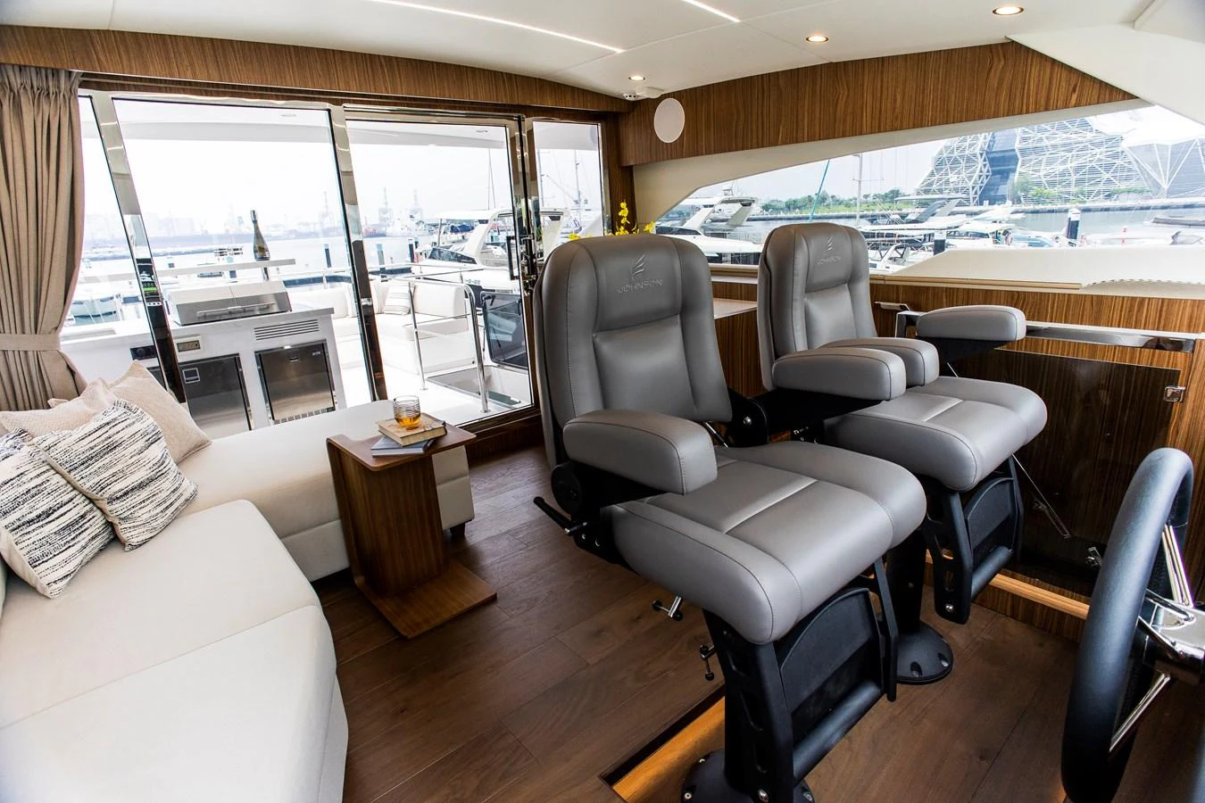 a living room with a large window aboard 70' JOHNSON SKYLOUNGE 2026 Yacht for Sale