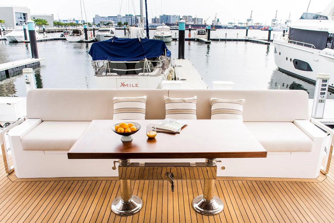 a table with a plate of food on it aboard 70' JOHNSON SKYLOUNGE 2026 Yacht for Sale
