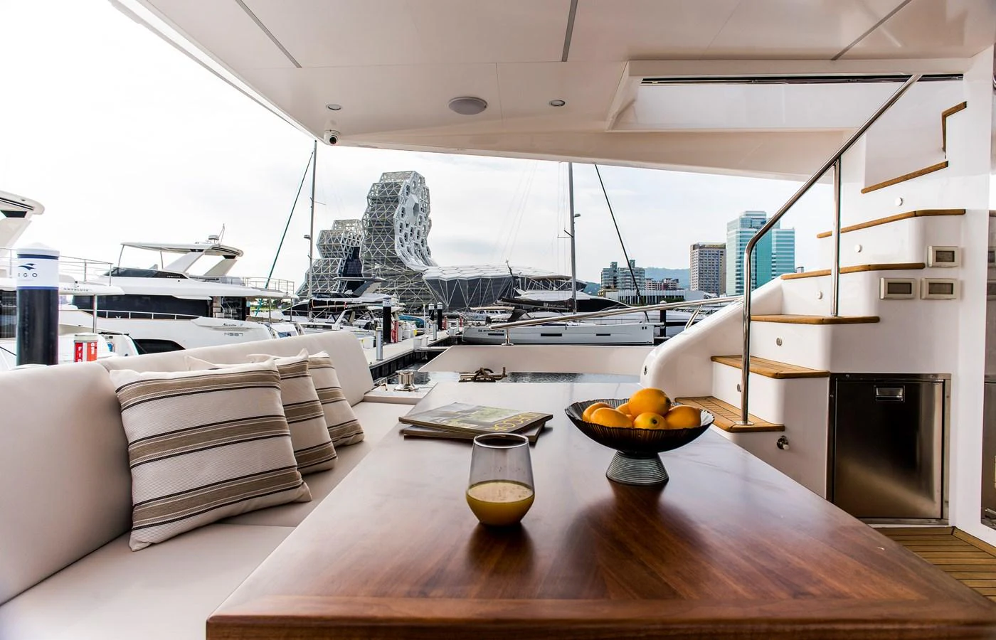 a modern looking living room with a large glass window aboard 70' JOHNSON SKYLOUNGE 2026 Yacht for Sale