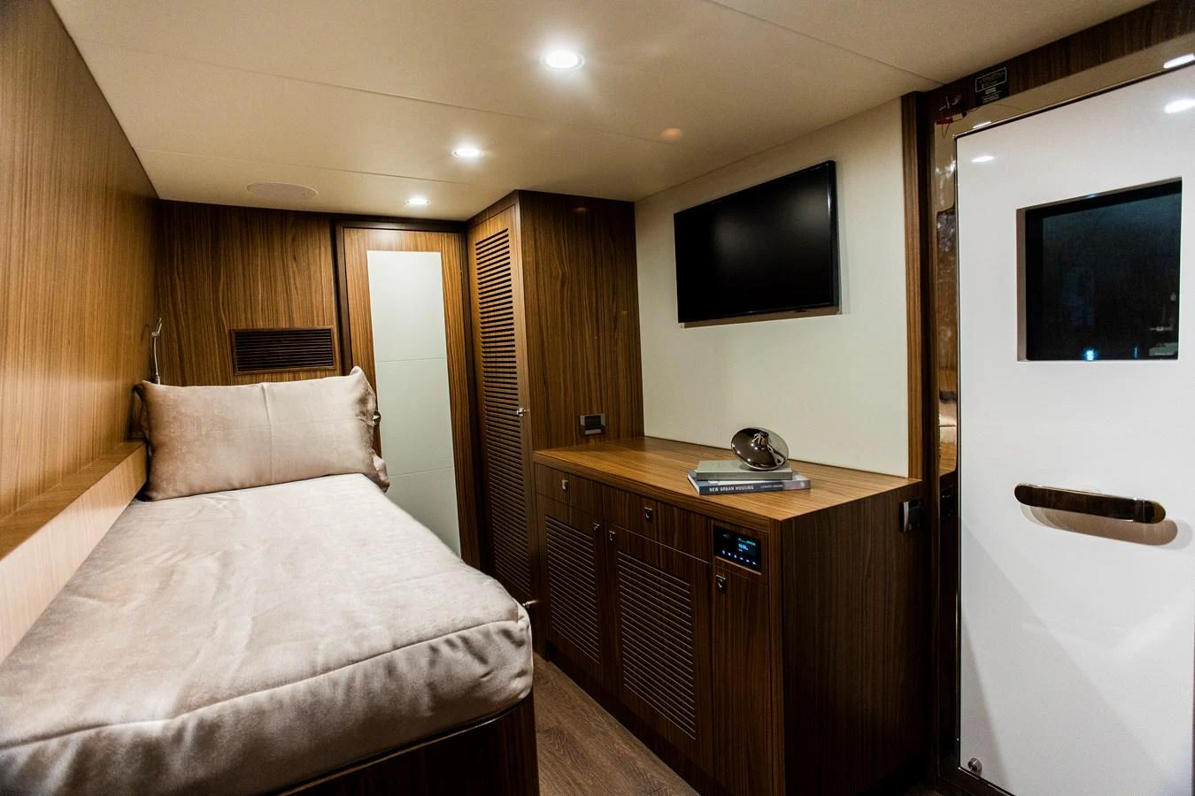 a hotel room with a bed and tv aboard 70' JOHNSON SKYLOUNGE 2026 Yacht for Sale