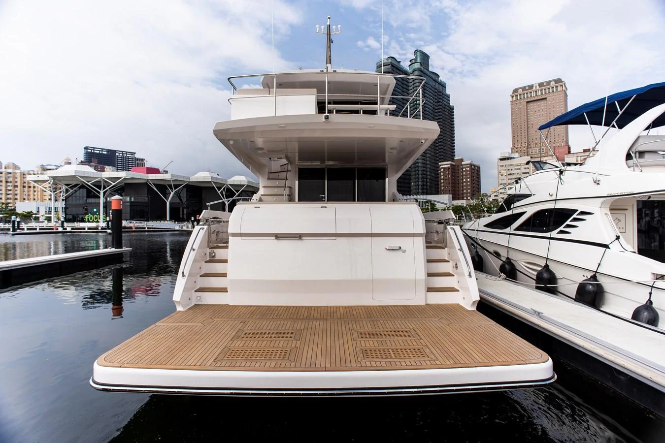 a boat docked at a pier aboard 70' JOHNSON SKYLOUNGE 2026 Yacht for Sale