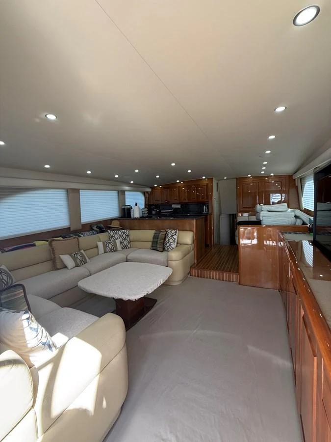 The yacht's salon features plush seating and elegant wood finishes, creating a comfortable and inviting atmosphere. aboard KICKBACK Yacht for Sale