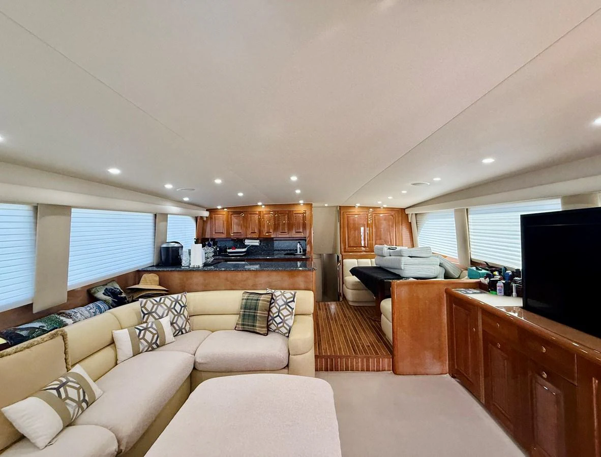The spacious salon features comfortable seating, a large TV, and a well-equipped galley. aboard KICKBACK Yacht for Sale
