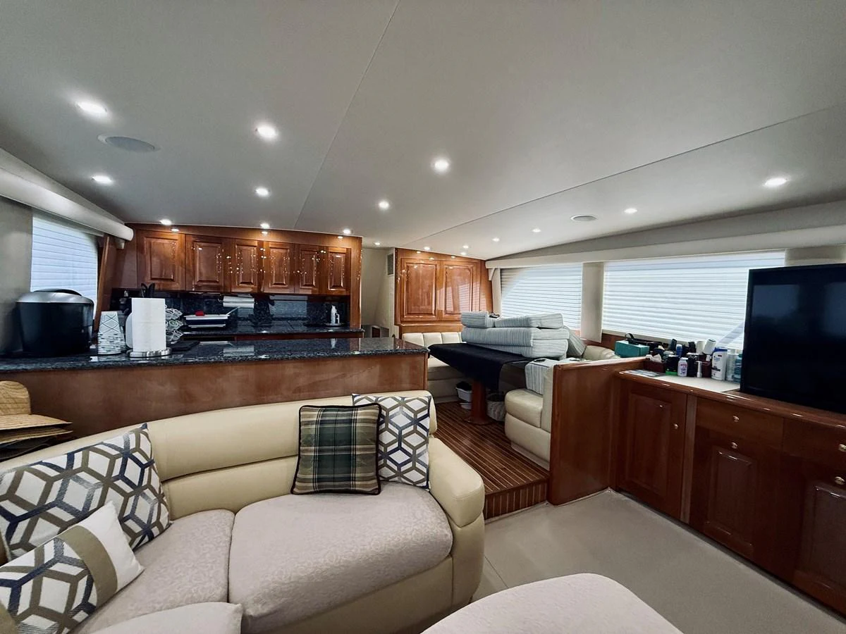 The salon features comfortable seating, a large TV, and a well-equipped galley area. aboard KICKBACK Yacht for Sale