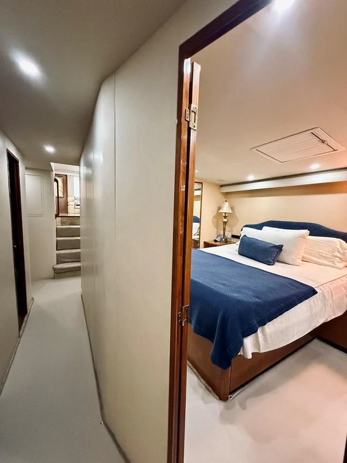 A cozy stateroom with a comfortable bed and elegant decor. aboard KICKBACK Yacht for Sale