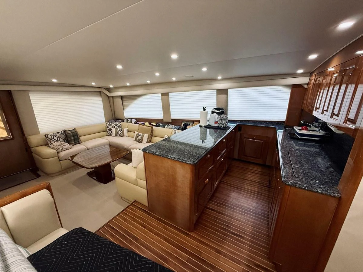 The yacht's salon features a spacious seating area with a central island and ample natural light. aboard KICKBACK Yacht for Sale