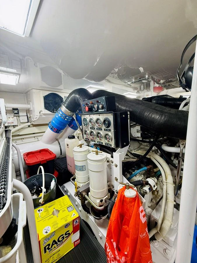 The image showcases the yacht's well-maintained engine room with various mechanical components and tools. aboard KICKBACK Yacht for Sale