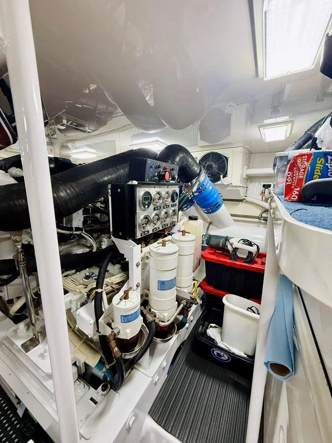 The image showcases the yacht's well-maintained engine room with various mechanical components and tools. aboard KICKBACK Yacht for Sale