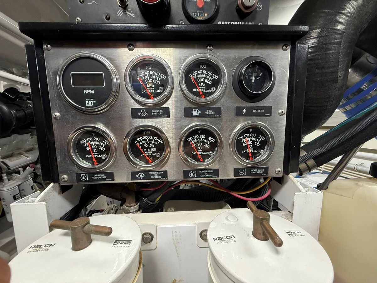 The image showcases the detailed control panel and gauges in the yacht's engine room. aboard KICKBACK Yacht for Sale