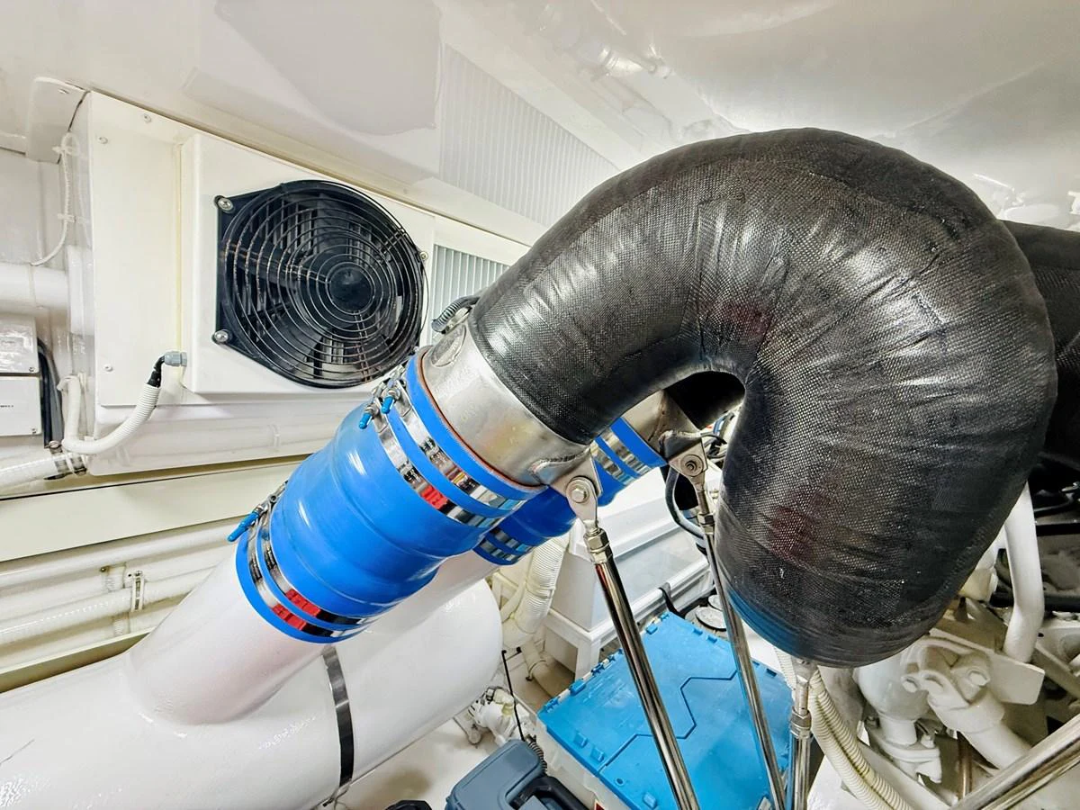 The image showcases a detailed view of the yacht's engine room, highlighting the mechanical components and piping. aboard KICKBACK Yacht for Sale