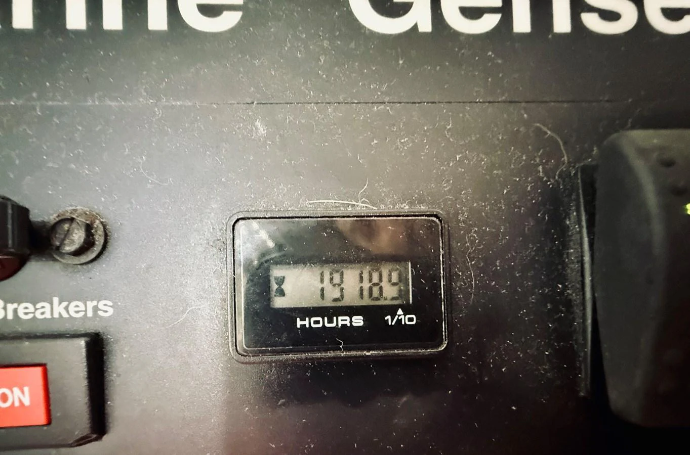 A close-up view of a digital hour meter on a yacht's control panel. aboard KICKBACK Yacht for Sale
