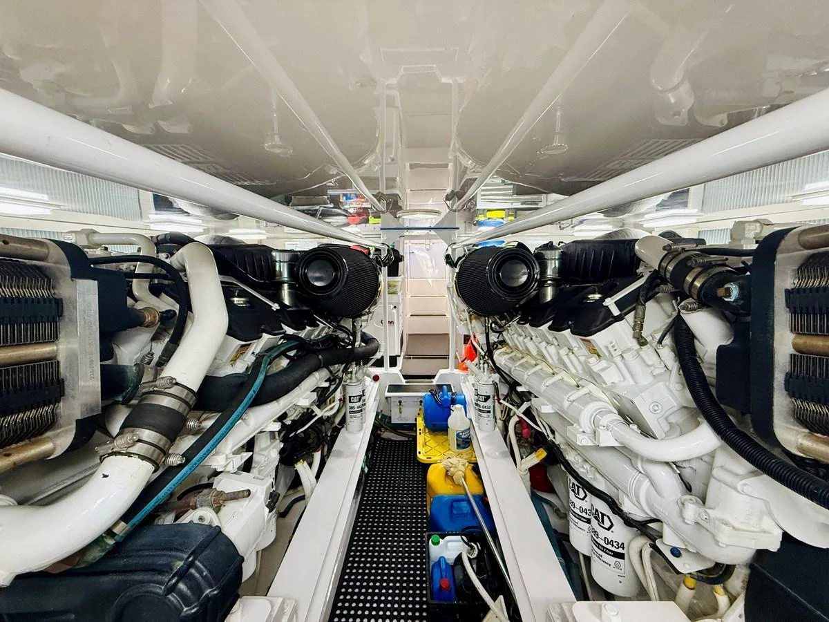 The image showcases the yacht's engine room with powerful engines and well-organized components. aboard KICKBACK Yacht for Sale