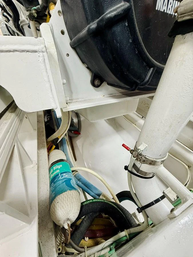 A close-up view of the yacht's engine room showcasing various mechanical components and safety equipment. aboard KICKBACK Yacht for Sale