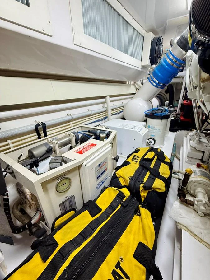 The image showcases the yacht's engine room with various equipment and tools neatly arranged. aboard KICKBACK Yacht for Sale