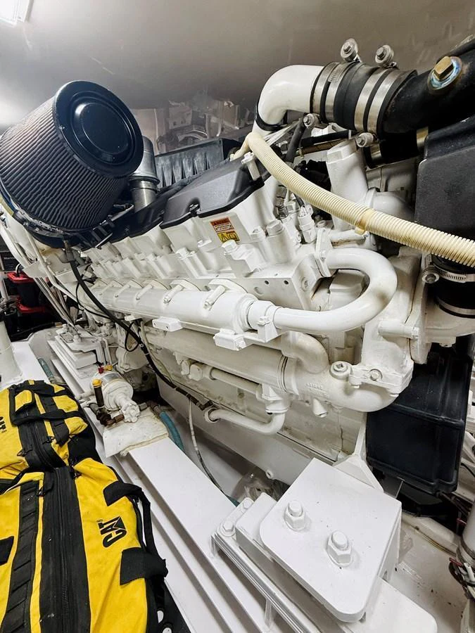 The image showcases the yacht's engine room with a focus on the powerful engine and surrounding components. aboard KICKBACK Yacht for Sale