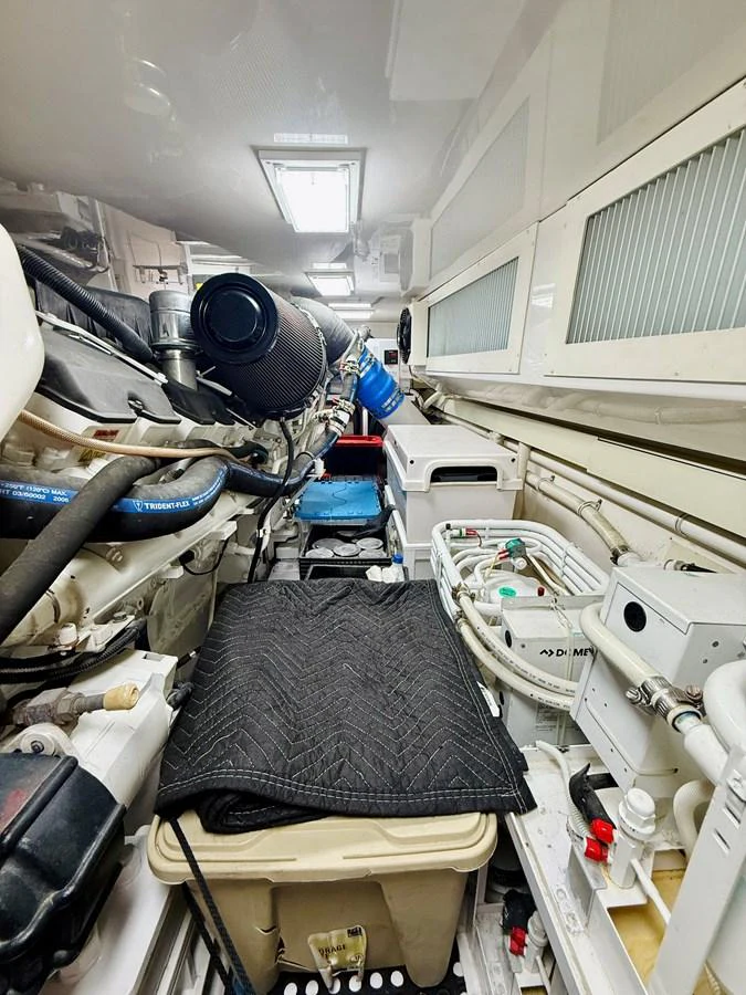 The image showcases the yacht's well-organized engine room with various mechanical components and systems. aboard KICKBACK Yacht for Sale