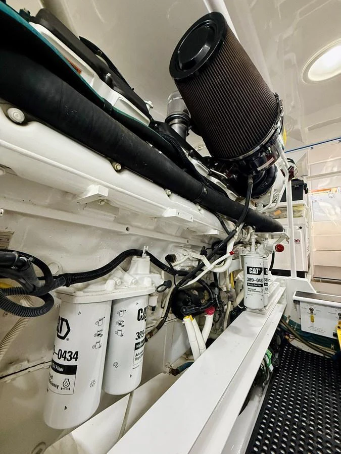 The image showcases the yacht's well-maintained engine room with visible filters and machinery. aboard KICKBACK Yacht for Sale