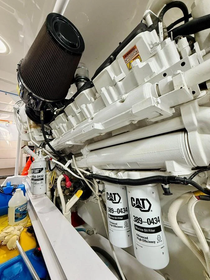 A close-up view of the yacht's engine room showcasing the mechanical components and filters. aboard KICKBACK Yacht for Sale