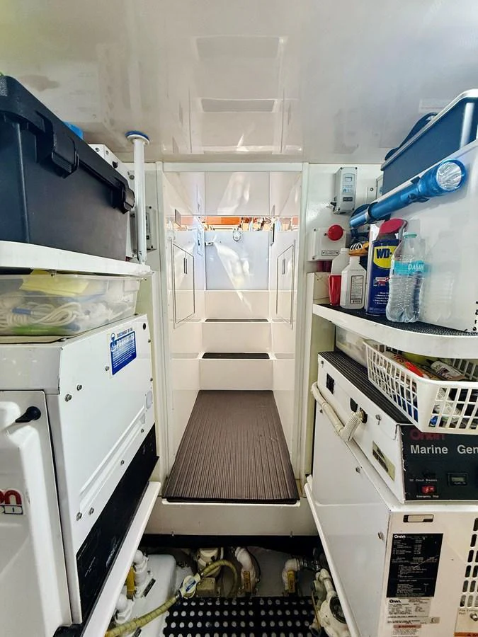 A functional and well-organized utility room with various equipment and storage solutions. aboard KICKBACK Yacht for Sale