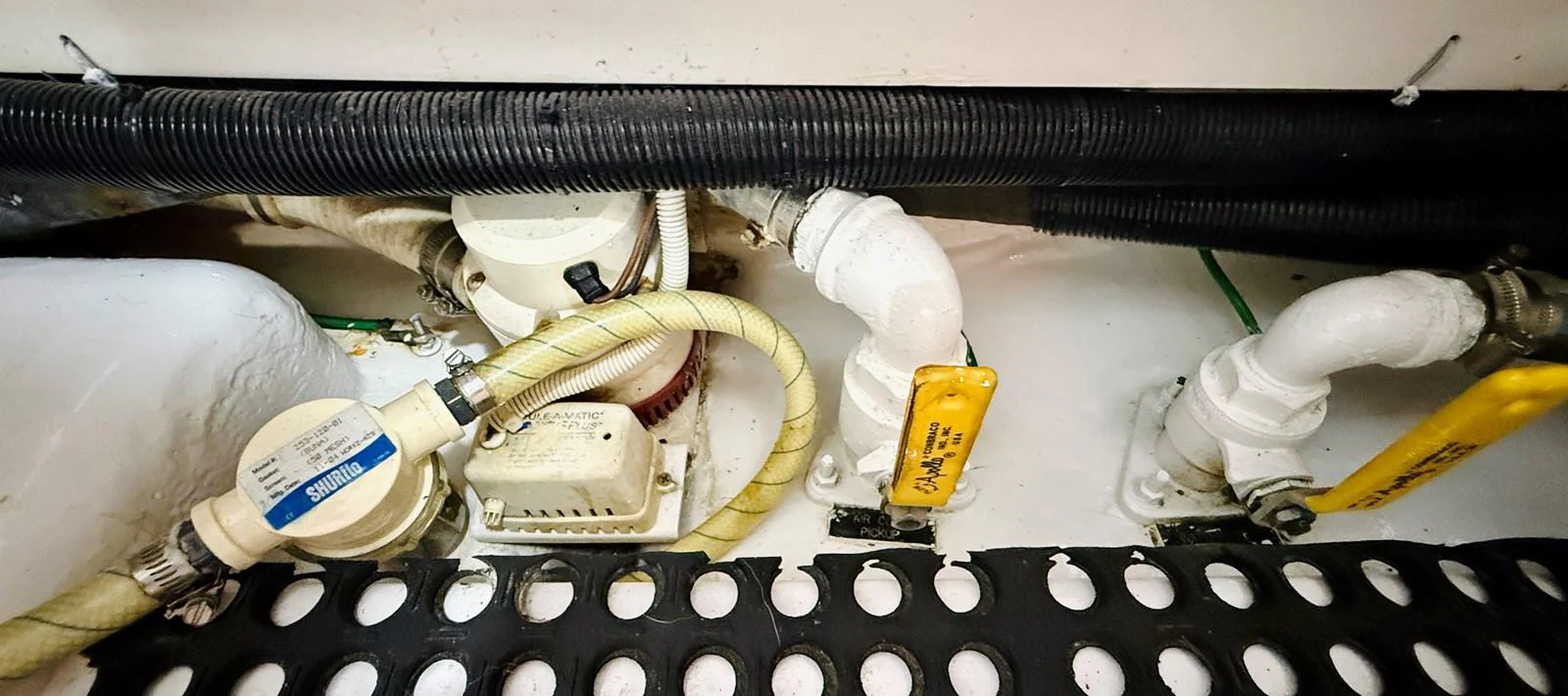 A close-up view of the yacht's engine room showcasing various pipes and fittings. aboard KICKBACK Yacht for Sale