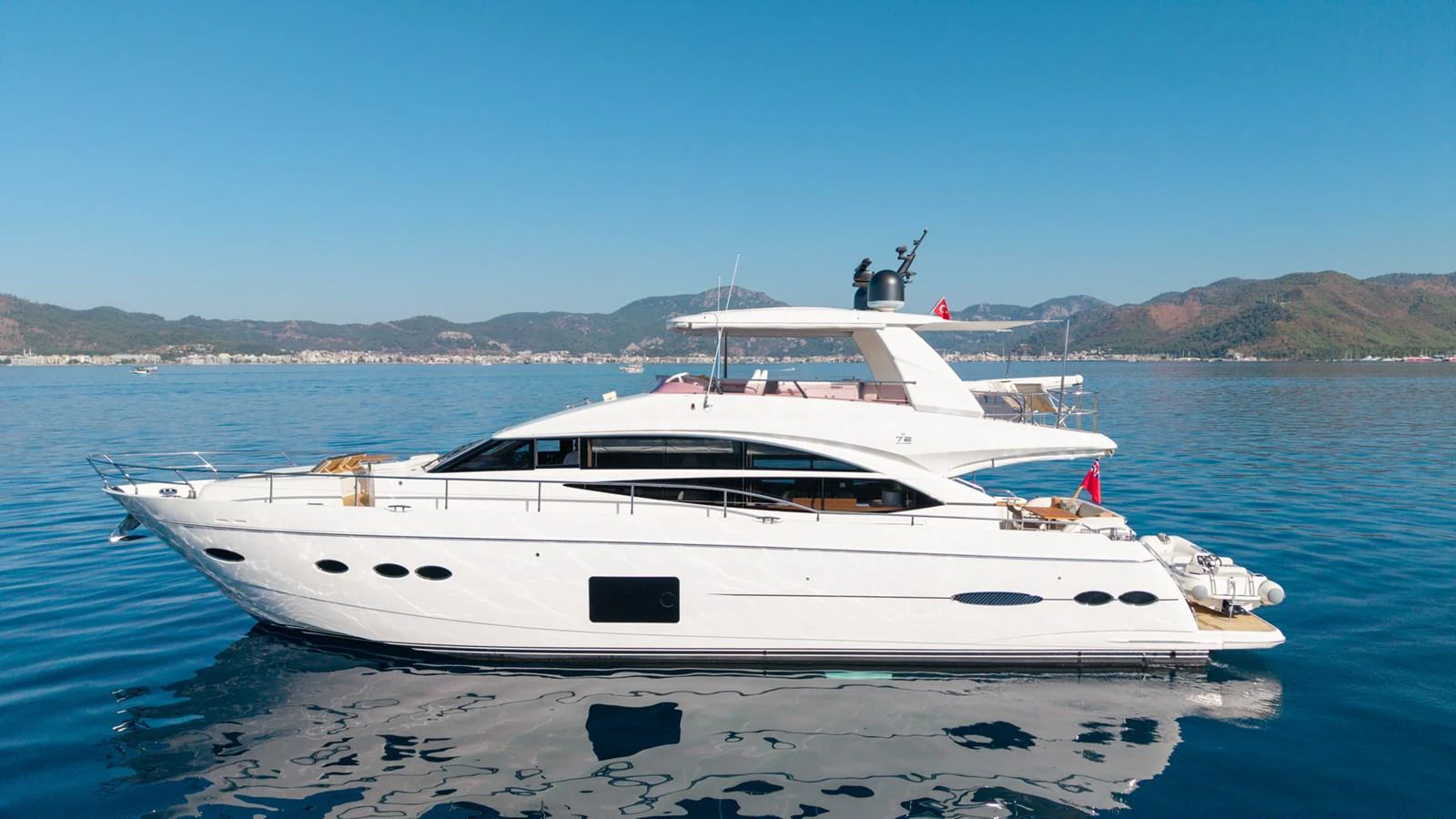 a white yacht on a beach aboard MY LADY Yacht for Sale