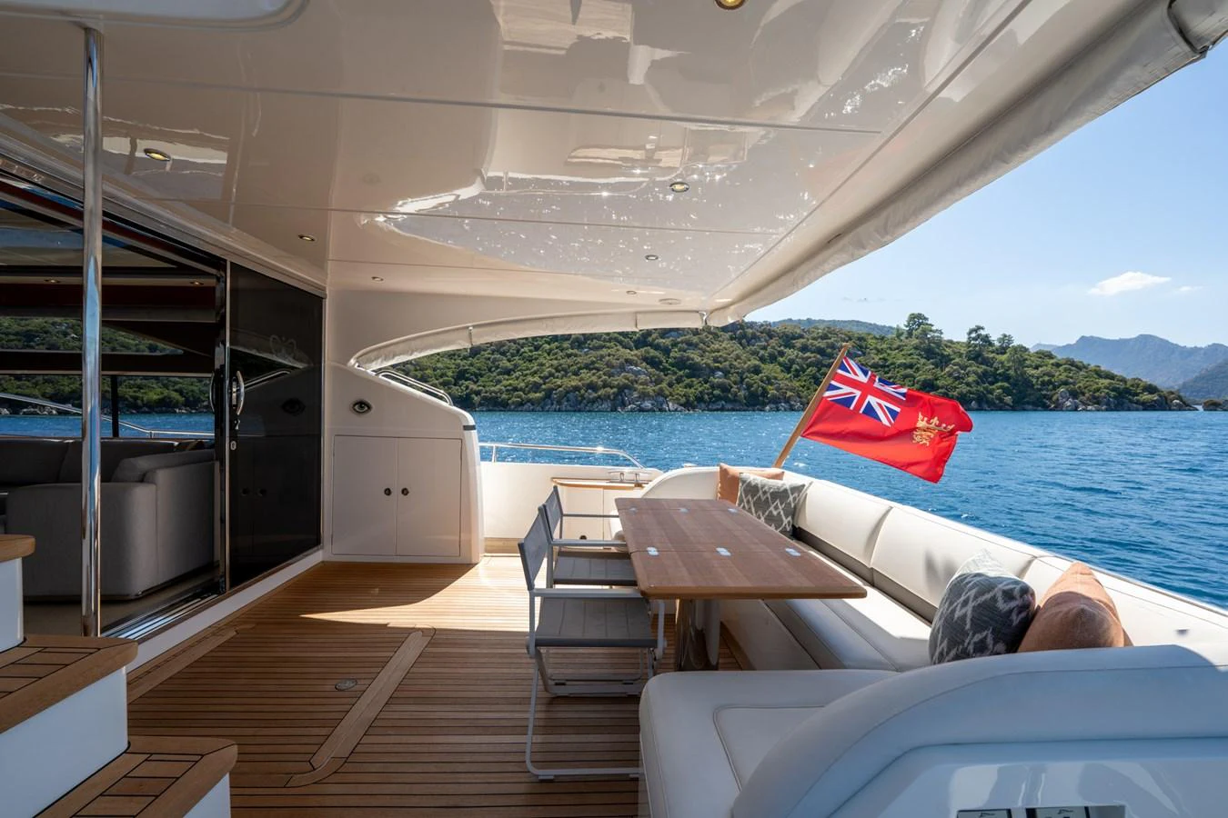 a boat with a table and chairs on it aboard MY LADY Yacht for Sale