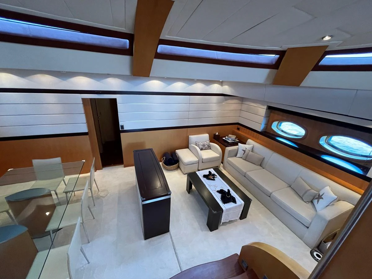 The salon features a spacious seating area with modern furnishings and ample natural light. aboard MUMU Yacht for Sale