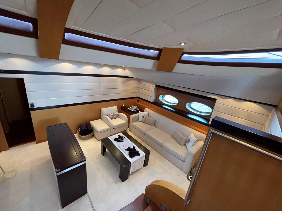 The yacht's salon features a comfortable seating area with modern furnishings and ample natural light. aboard MUMU Yacht for Sale