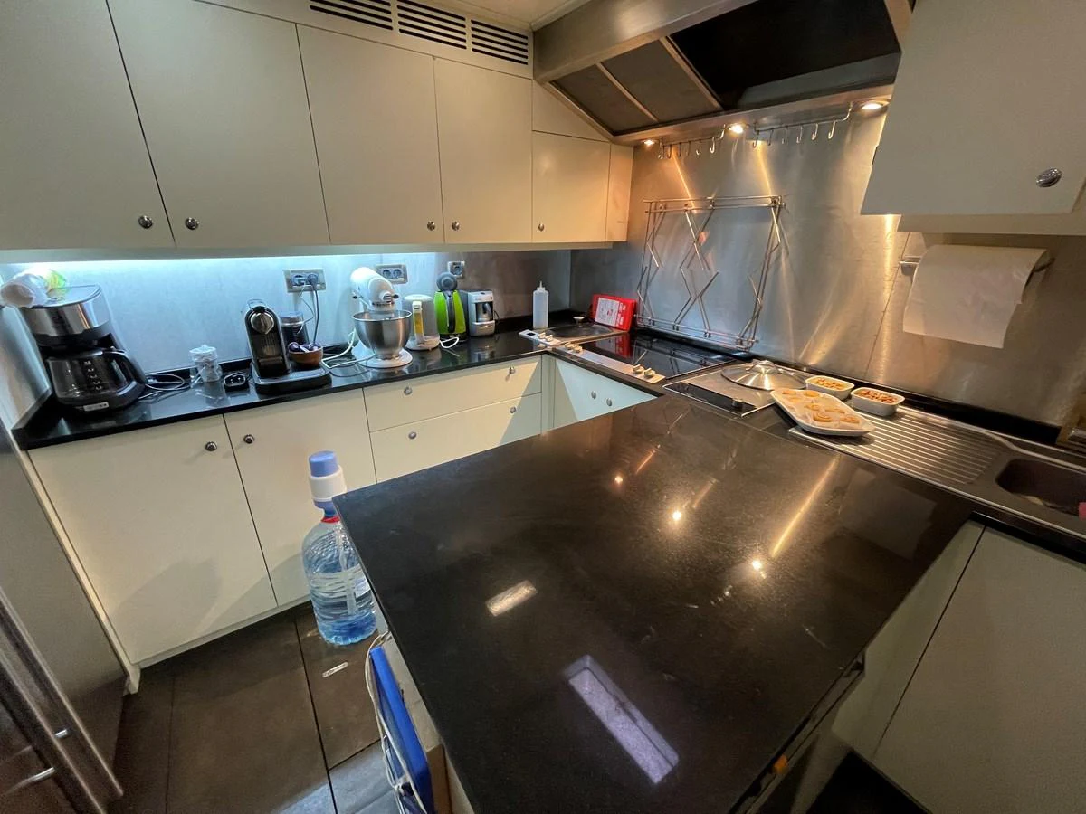 The yacht's galley is equipped with modern appliances and ample counter space for meal preparation. aboard MUMU Yacht for Sale