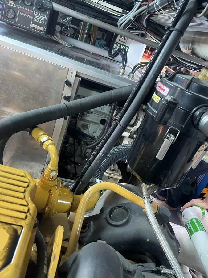The image shows a detailed view of the yacht's engine room, highlighting various mechanical components and systems. aboard MUMU Yacht for Sale