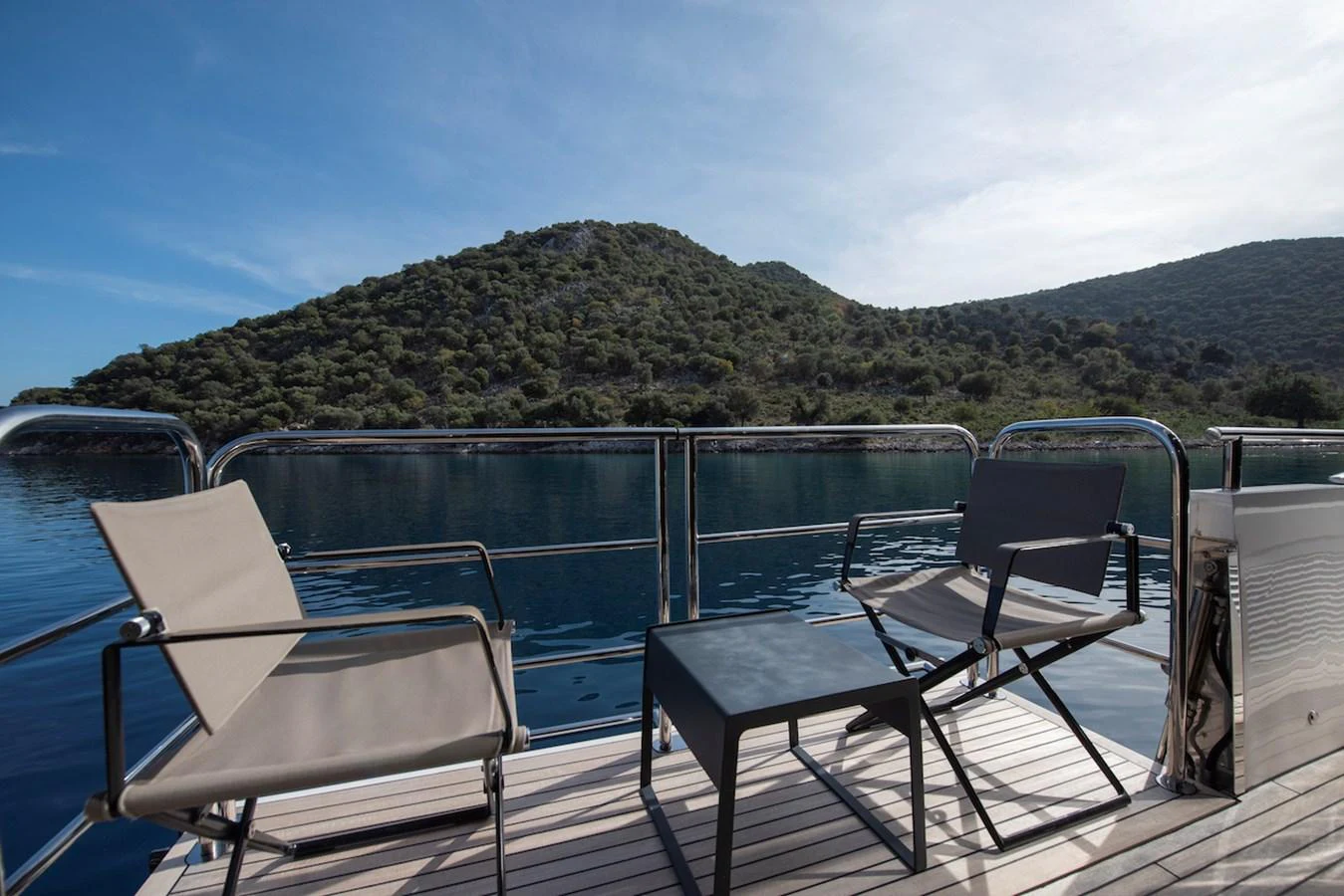 a deck with chairs and a table on it aboard LADY PARISA Yacht for Sale