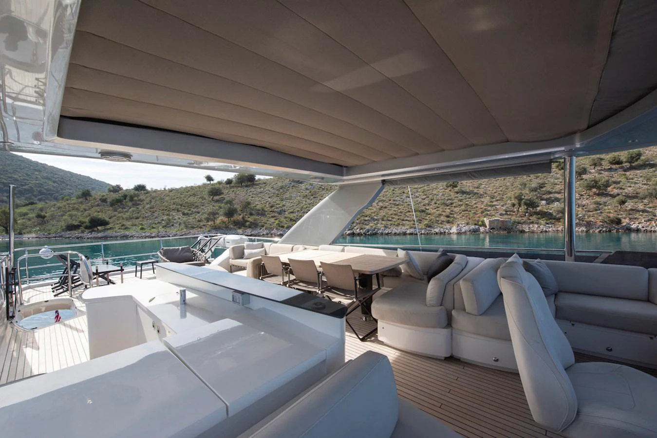 a large patio with a large white couch and a pool aboard LADY PARISA Yacht for Sale