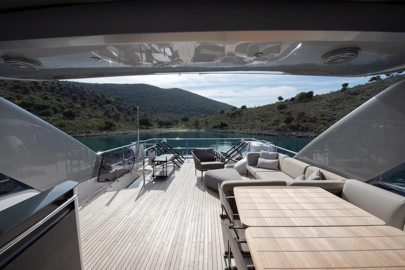a deck with chairs and a table on it aboard LADY PARISA Yacht for Sale