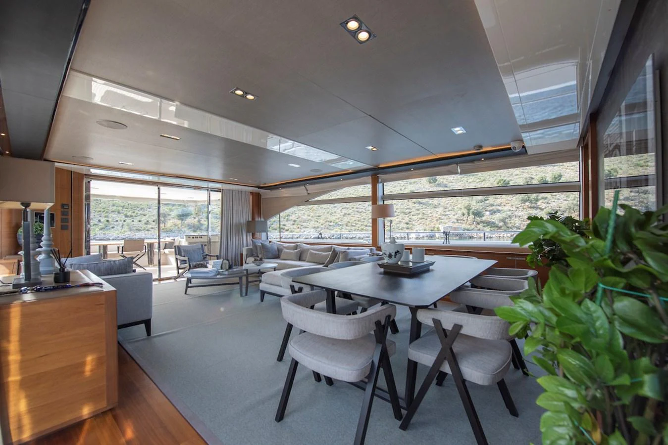 a room with a table and chairs aboard LADY PARISA Yacht for Sale