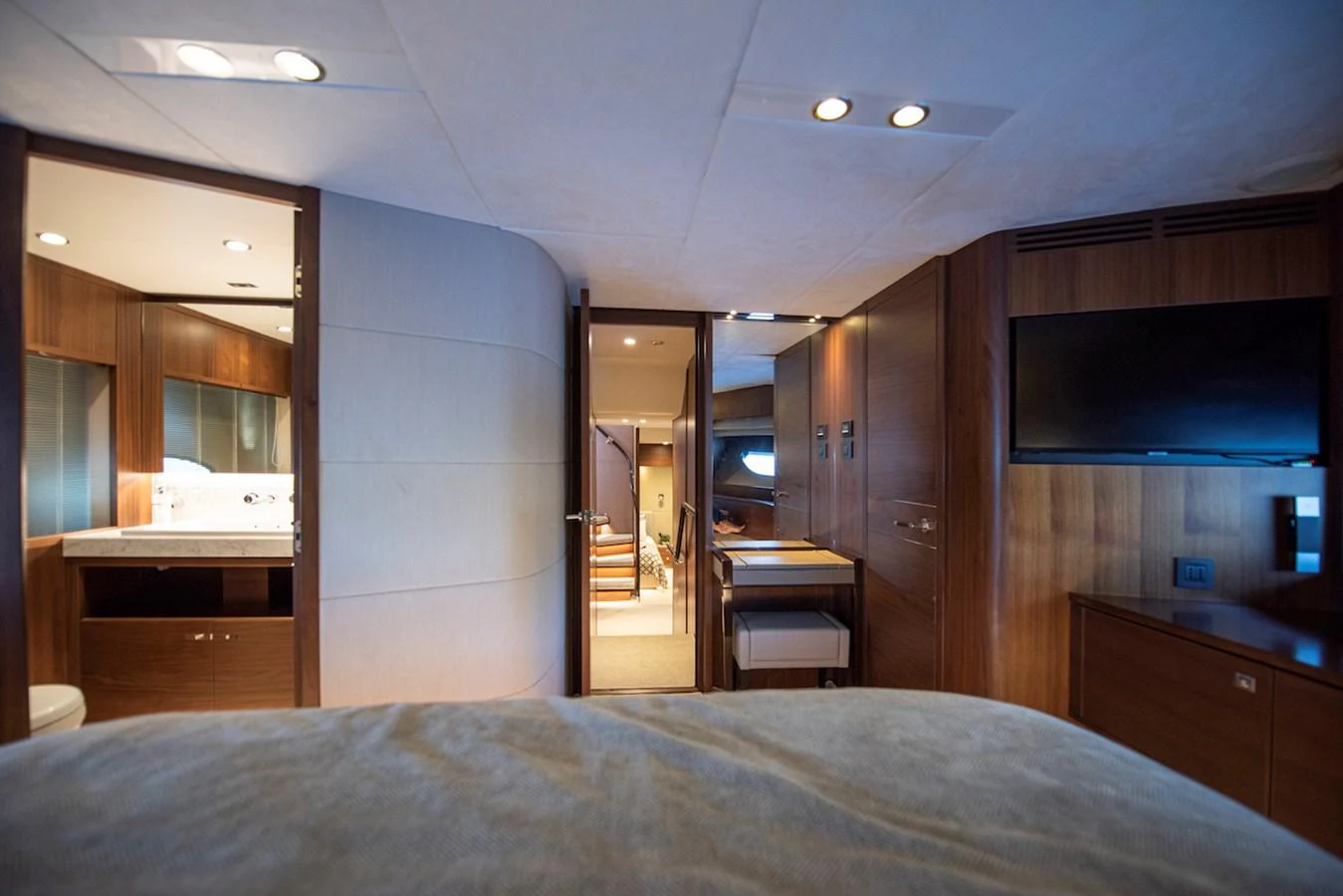 a bedroom with a bed and desk aboard LADY PARISA Yacht for Sale
