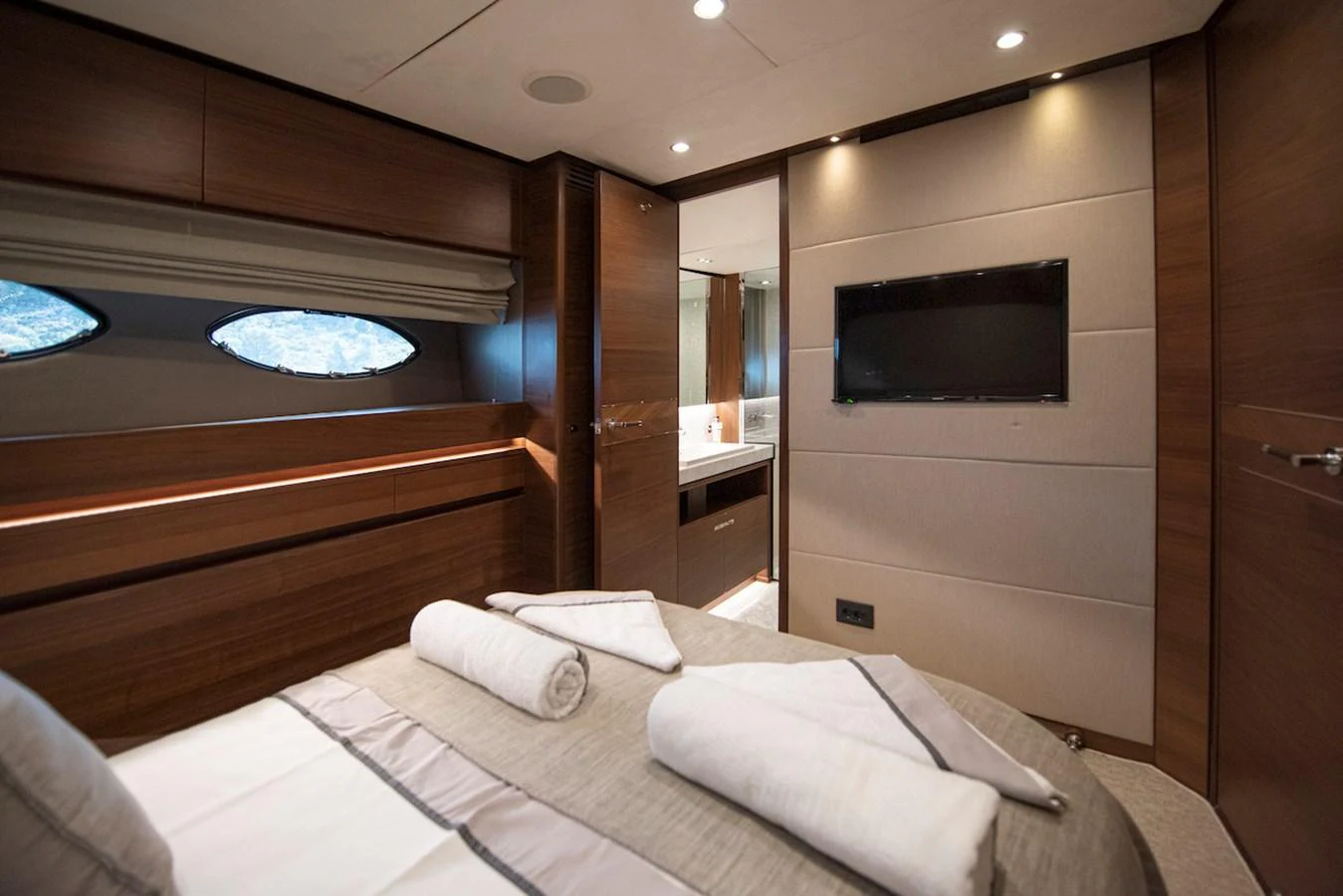a room with a bed and a television aboard LADY PARISA Yacht for Sale