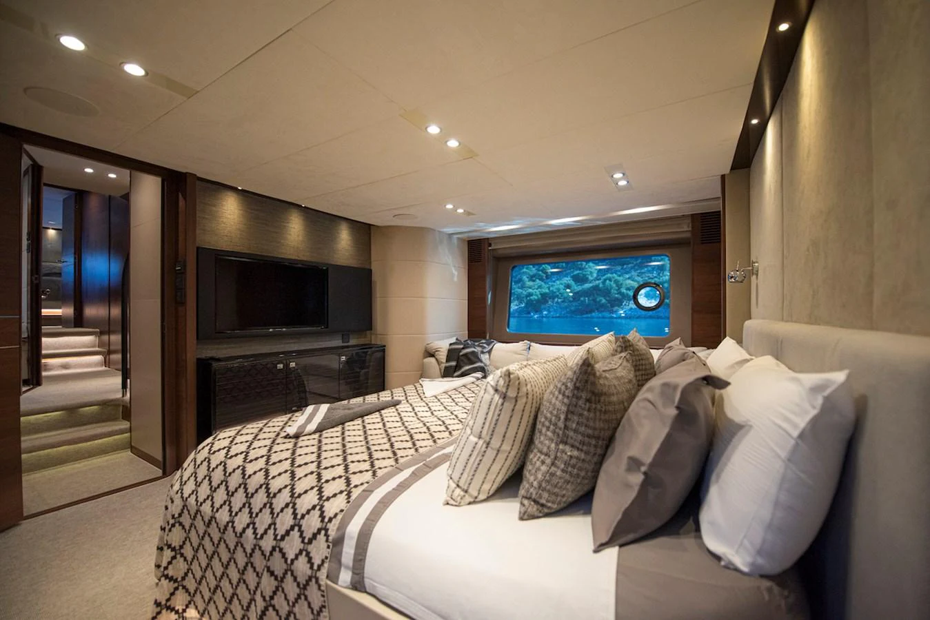 a bedroom with a bed and a tv aboard LADY PARISA Yacht for Sale