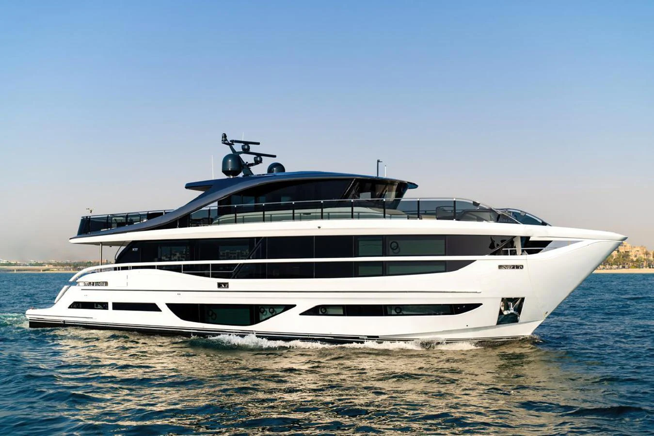 A sleek and modern yacht cruising on calm waters under a clear sky. aboard SEMIA Yacht for Sale